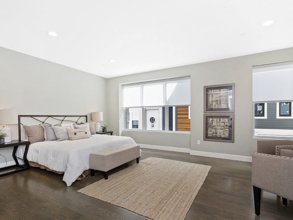 260 Gold Street, Unit 1 Boston, MA 02127 - Photo 7 of 16 a bedroom with a large bed and a couch
