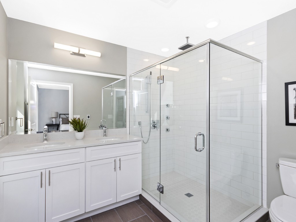 260 Gold Street, Unit 1 Boston, MA 02127 - Photo 8 of 16 a bathroom with a shower sink vanity mirror and toilet
