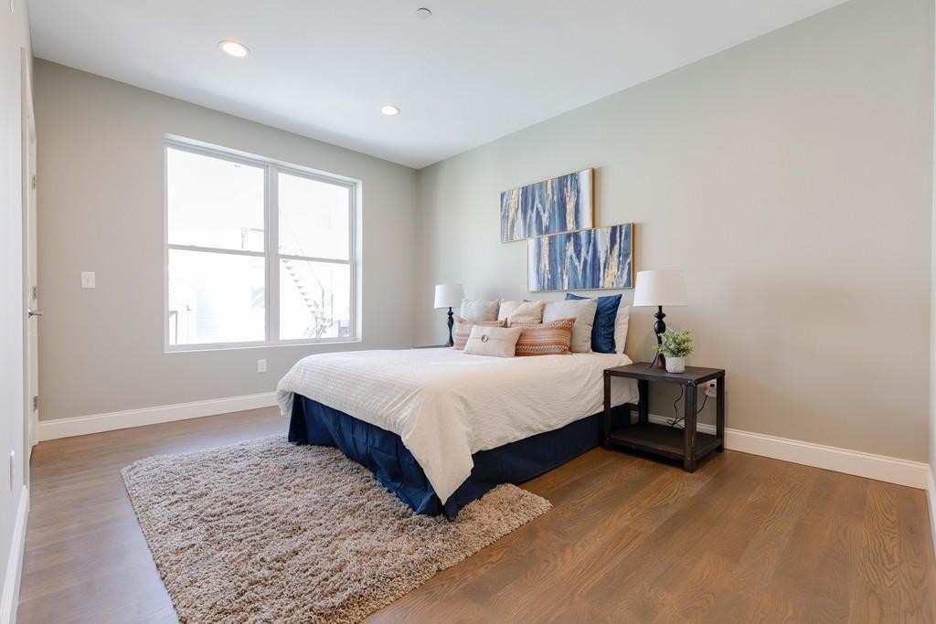 260 Gold Street, Unit 1 Boston, MA 02127 - Photo 9 of 16 a bedroom with a large bed and a window