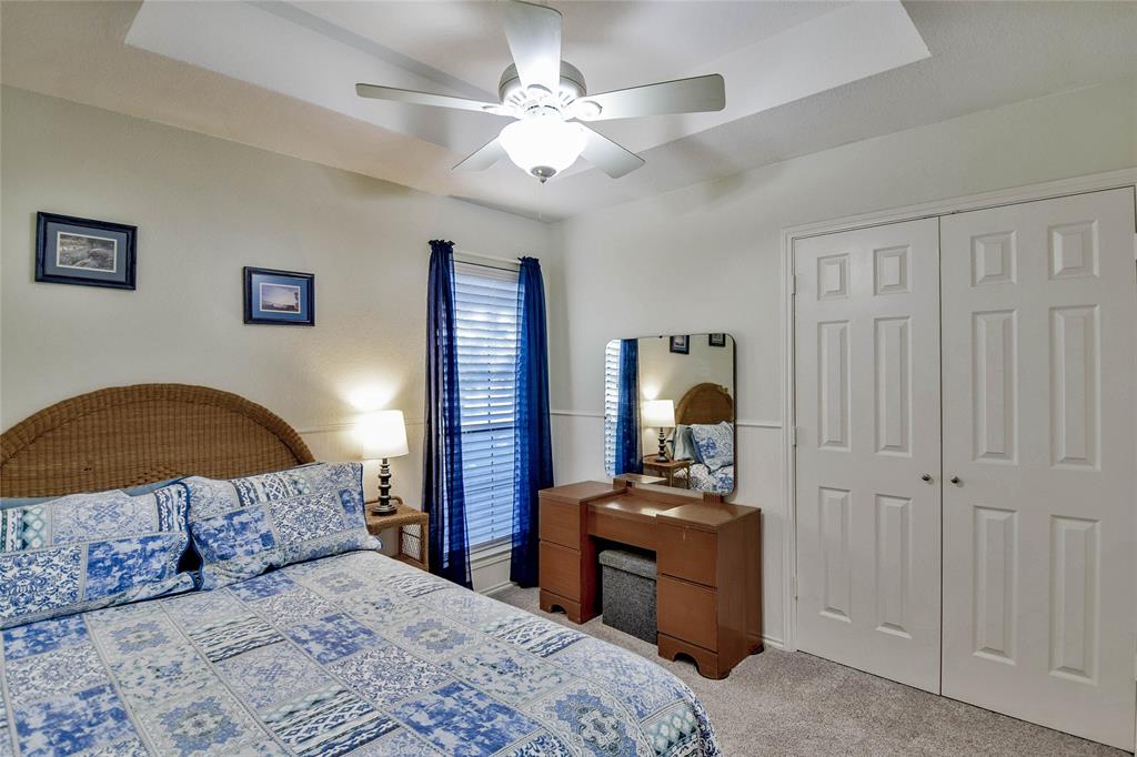 9100 Bellechase Road Granbury, TX 76049 - Photo 11 of 37 a bedroom with a bed and a chandelier