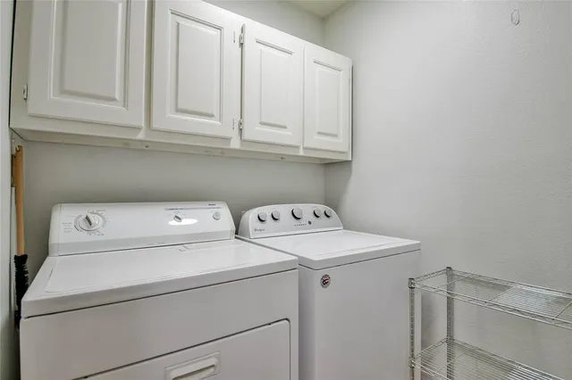 a view of storage and utility room with washer and dryer