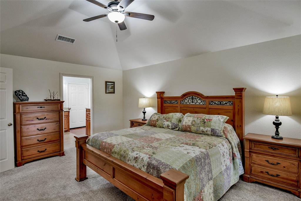 9100 Bellechase Road Granbury, TX 76049 - Photo 27 of 37 a bedroom with a bed and a dresser