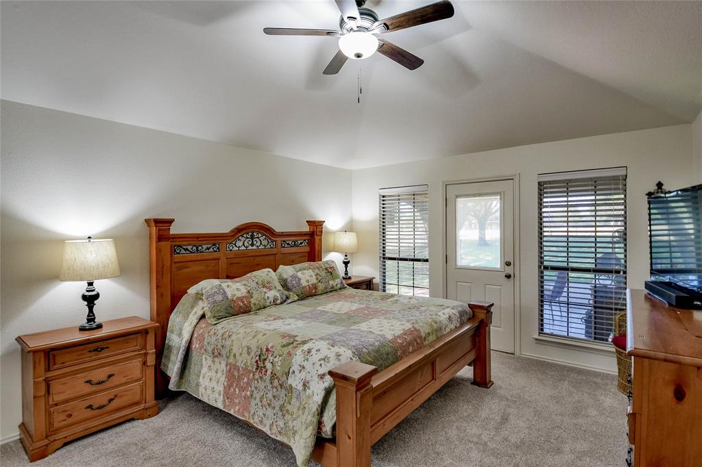 9100 Bellechase Road Granbury, TX 76049 - Photo 28 of 37 a spacious bedroom with a bed and window