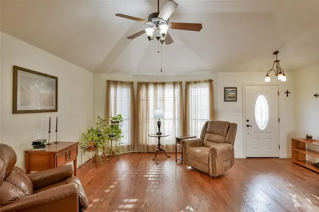 a living room with furniture and wooden floor