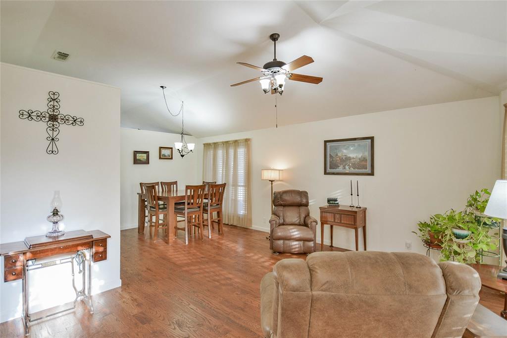 9100 Bellechase Road Granbury, TX 76049 - Photo 10 of 37 a living room with furniture a dining table and a potted plant
