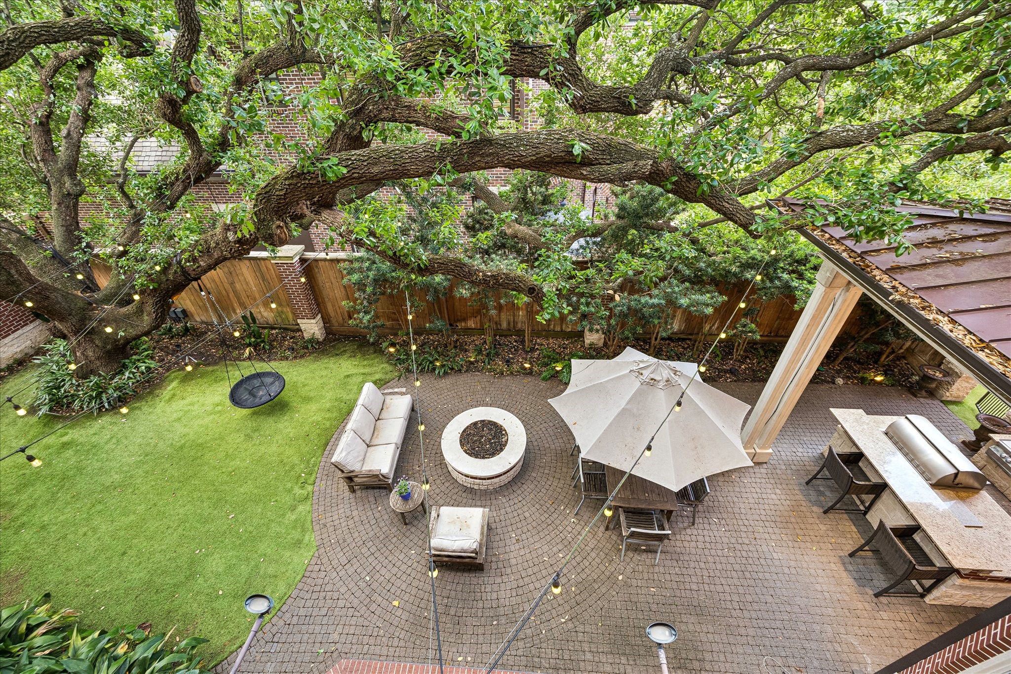By evening, the lovely bistro lights and extensive landscape lighting plan encourage gatherings around the custom fire pit. An imported marble fountain add to the tranquility of this space. The courtyard features engineered turf, a row of Japanese Yew for additional privacy, and extensive professional landscaping.