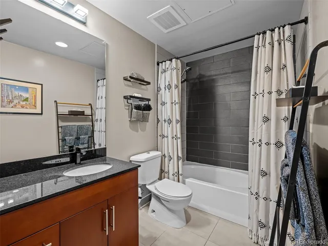 a view of bathroom with washing machine and shower