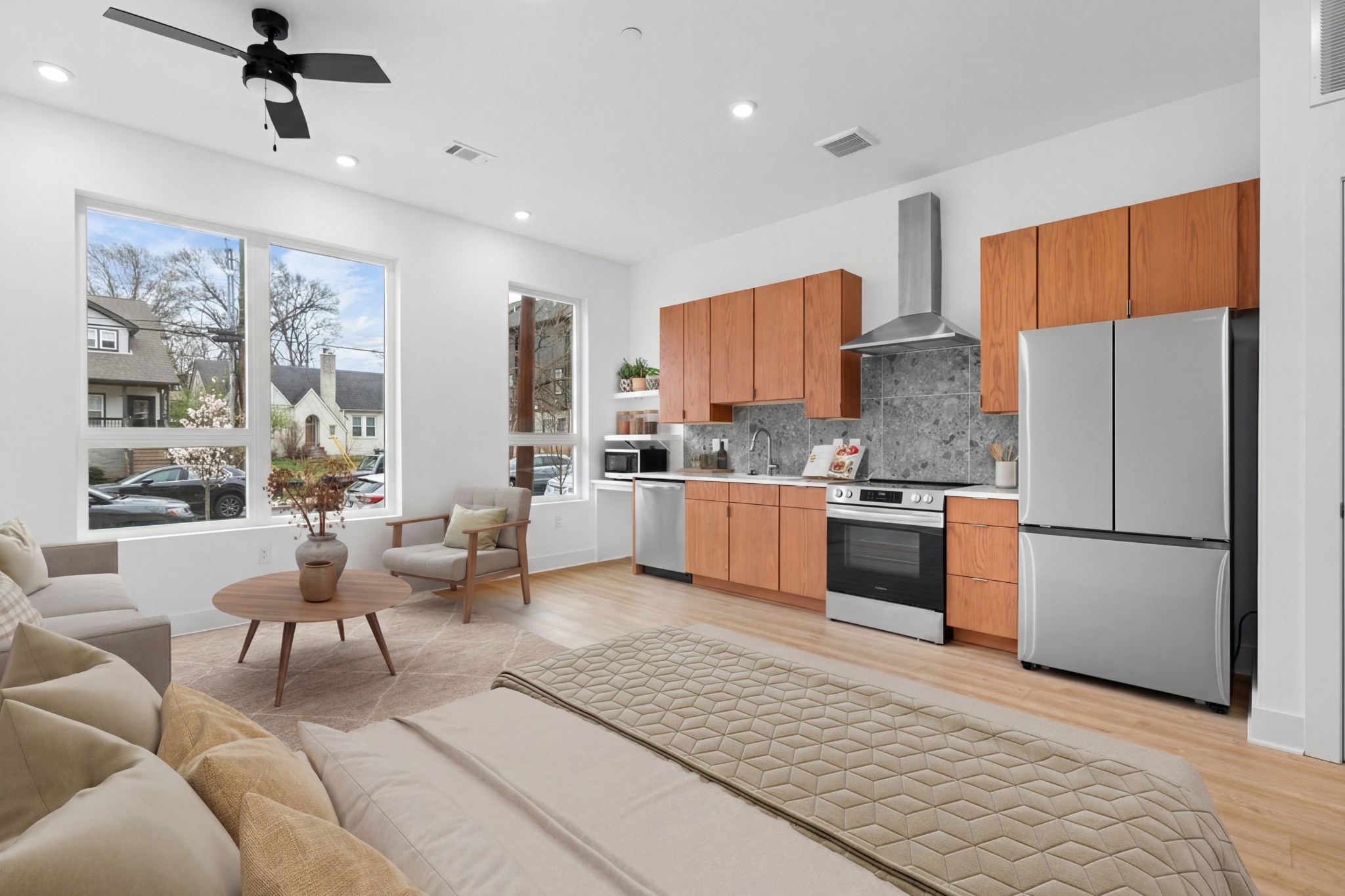 a kitchen with stainless steel appliances granite countertop a refrigerator a oven a sink a dining table and chairs with wooden floor