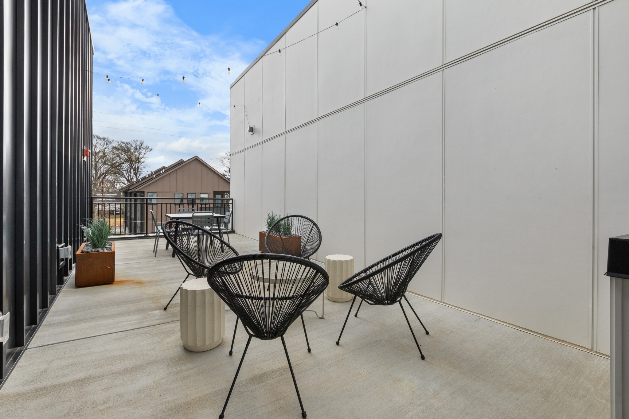 1310 Lischey Avenue, Unit 104 Nashville, TN 37207 - Photo 25 of 28 a roof deck with table and chairs and potted plants