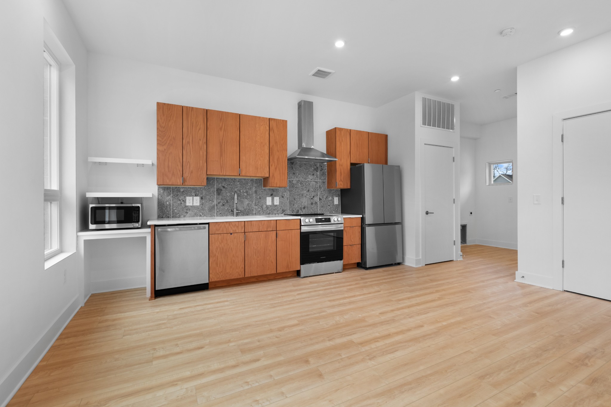 1310 Lischey Avenue, Unit 104 Nashville, TN 37207 - Photo 10 of 28 a large kitchen with stainless steel appliances granite countertop a stove a sink and a refrigerator