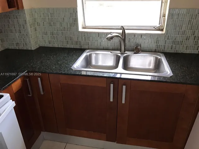 a bathroom with a sink vanity and a mirror