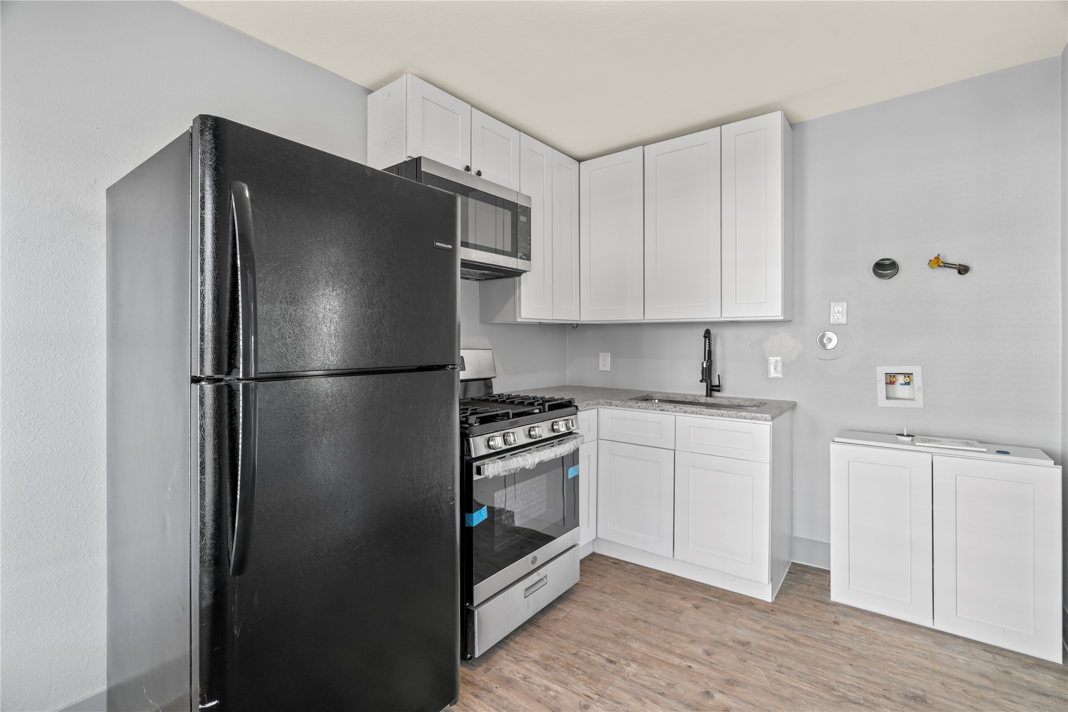 305 Roberts Street, Unit 2 Houston, TX 77003 - Photo 5 of 6 a kitchen with stainless steel appliances granite countertop a refrigerator and a sink
