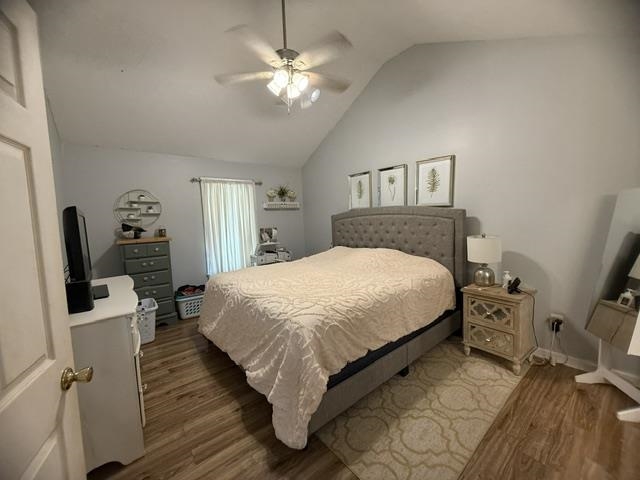 395 Austin Street Savannah, TN 38372 - Photo 9 of 32 Vaulted ceiling with a ceiling fan light fixture, wood-finish flooring, and a window with white blinds