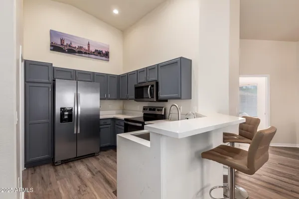 a kitchen with stainless steel appliances a refrigerator and a stove top oven