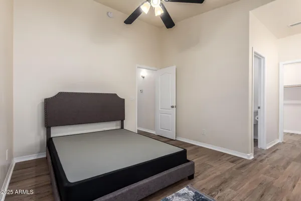 a room with a bed and a ceiling fan