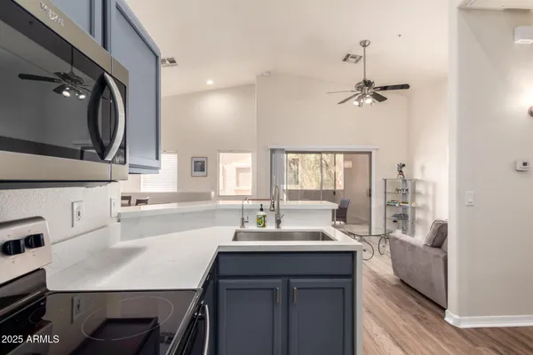 a kitchen with a sink appliances and a window