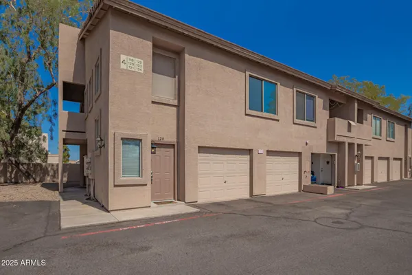 a front view of a house with a parking space