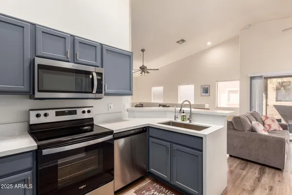 a kitchen with a sink stove and microwave