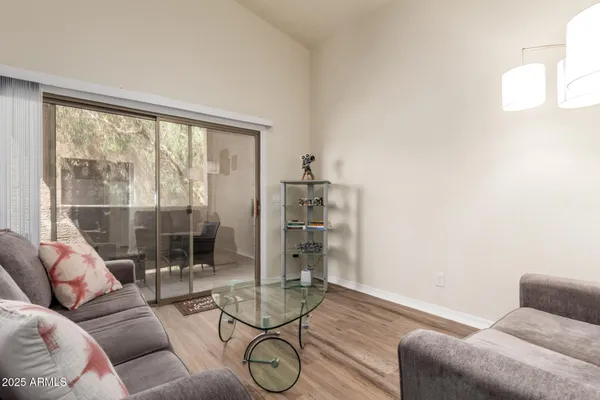 a living room with furniture and a floor to ceiling window