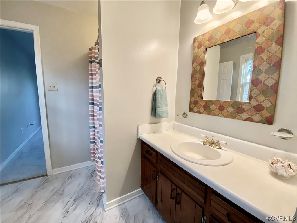 2618 Iverson Road Midlothian, VA 23112 - Photo 36 of 50 a bathroom with a sink and a mirror