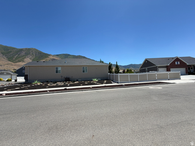 118 Tram Rock Rd. Lake Point, UT 84074 - Photo 4 of 34 Single-story residence featuring a neutral exterior, dark shingle roof, and a perimeter fence