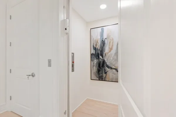 a kitchen with stainless steel appliances kitchen island granite countertop a table chairs sink and white cabinets