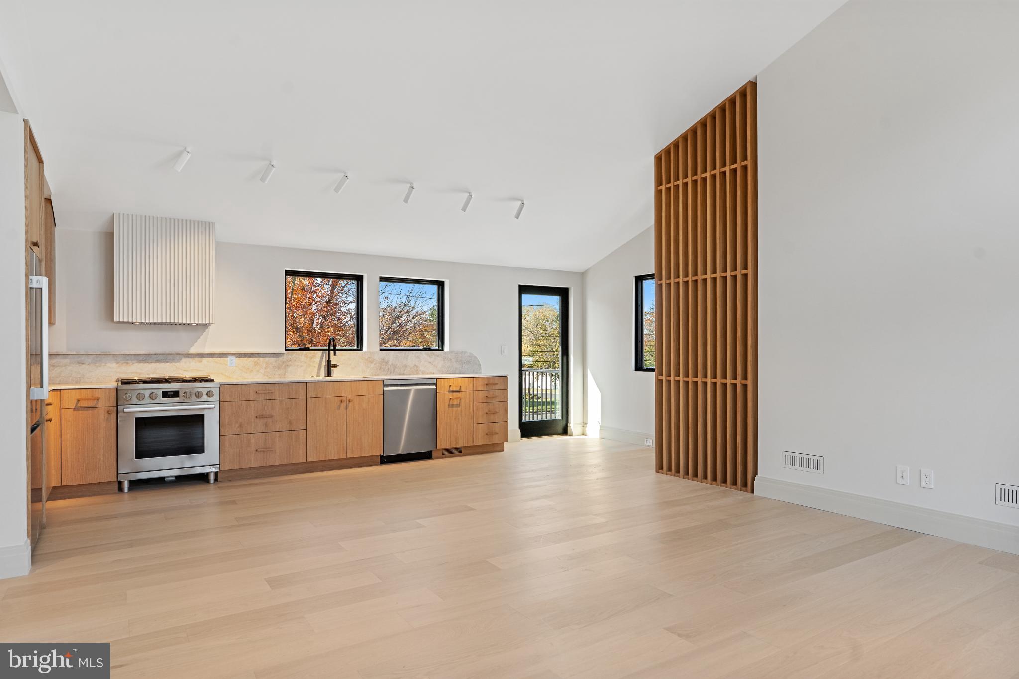 a kitchen with stainless steel appliances a stove top oven and a refrigerator