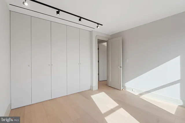 a view of walk in closet with empty racks