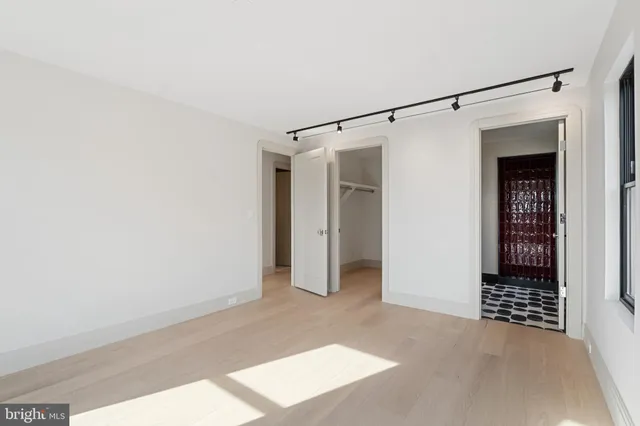 a view of walk in closet with empty racks