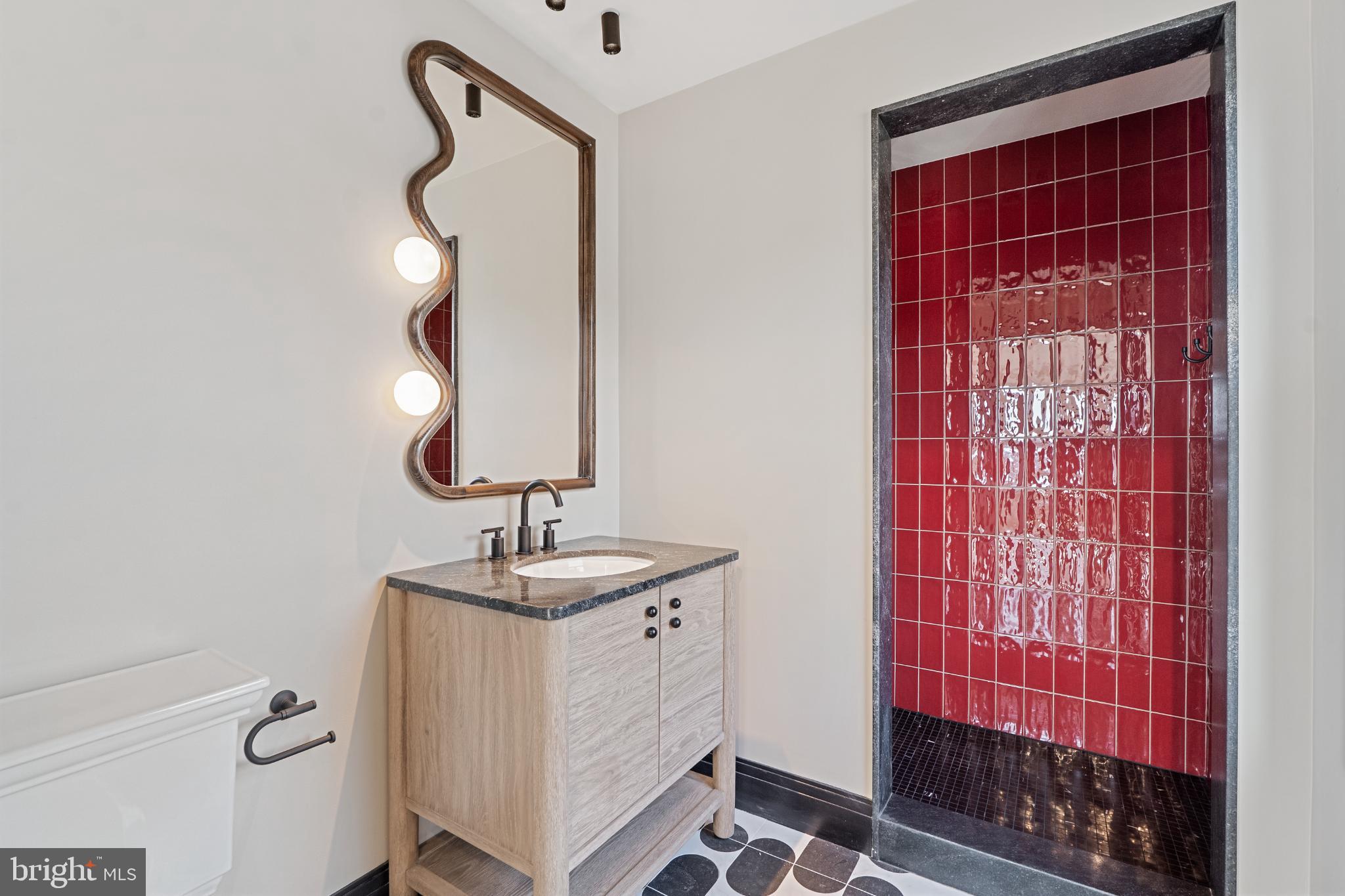 501 Haddonfield-Berlin Road, Unit 2 Voorhees, NJ 08043 - Photo 17 of 18 a bathroom with a sink a mirror and shower