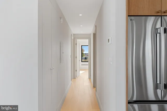 a view of a hallway with wooden floor and entryway