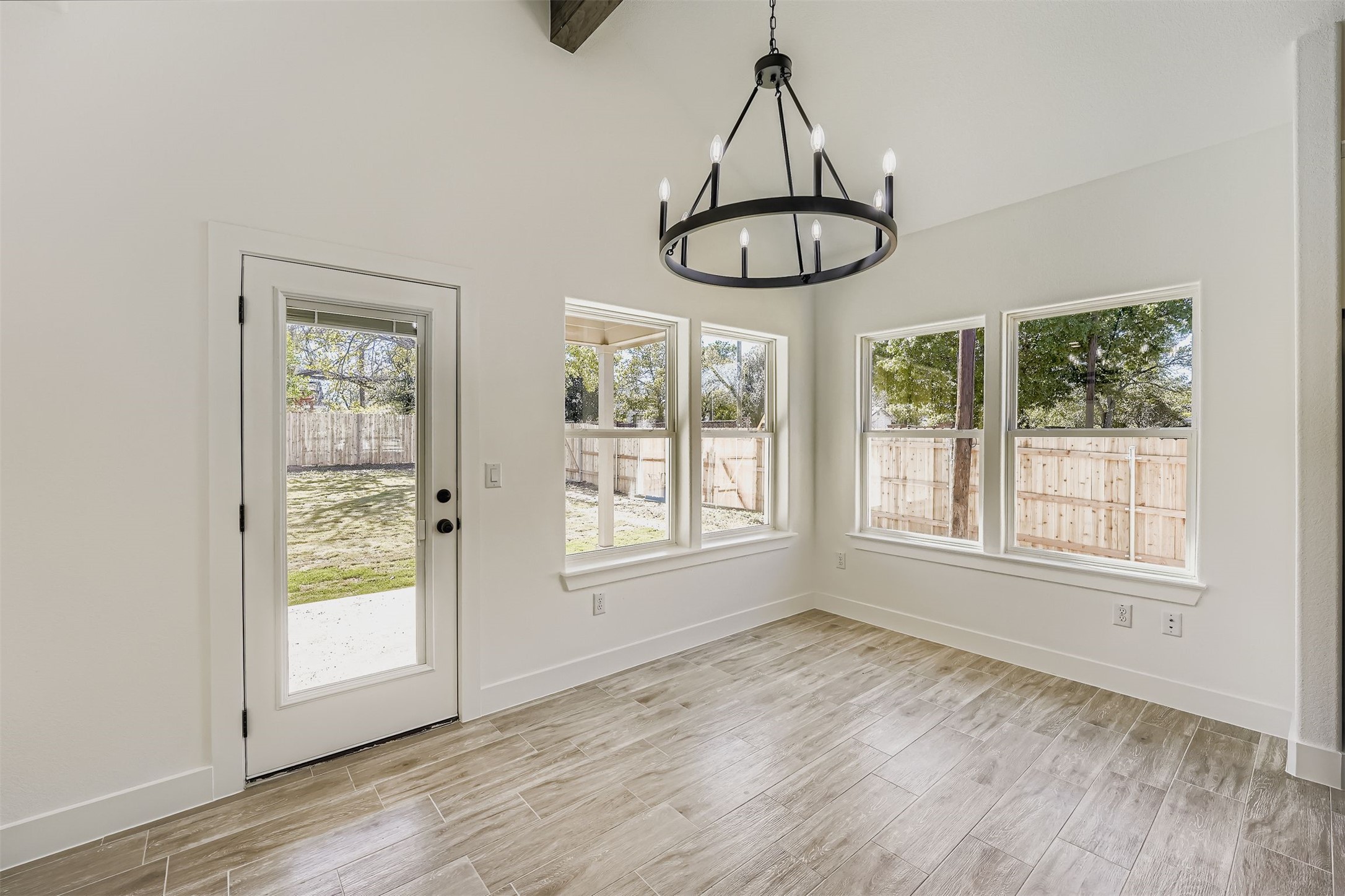 701 East 3rd Street Elgin, TX 78621 - Photo 10 of 35 Dining area featuring a chandelier and wood-style vinyl plank floors