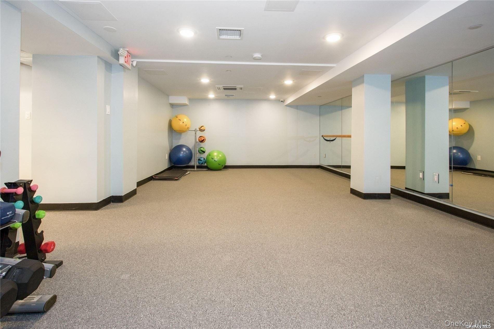 2 Richmond Road, Unit 4V Lido Beach, NY 11561 - Photo 7 of 24 a view of a room with gym equipment and a chandelier