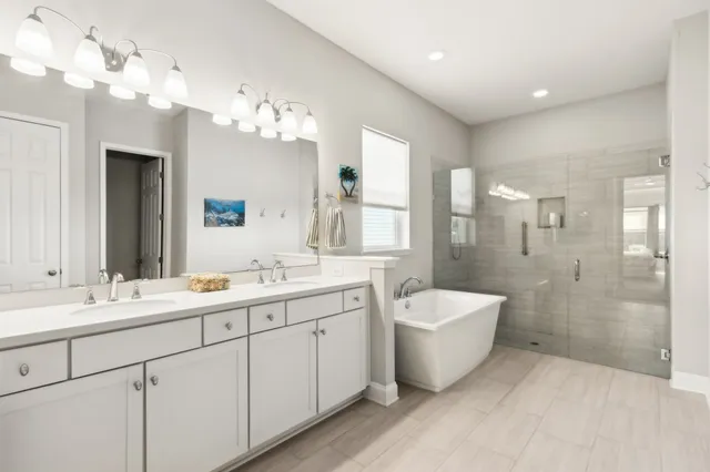 a bathroom with a sink toilet mirror and shower