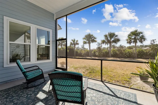an aerial view of a residential houses with outdoor space and street view