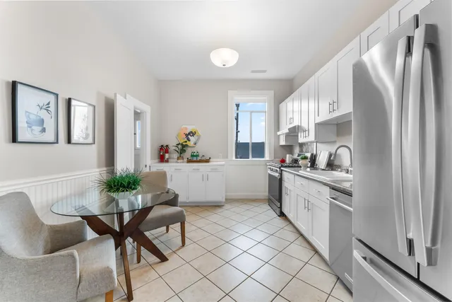 a kitchen with stainless steel appliances granite countertop a sink and a refrigerator