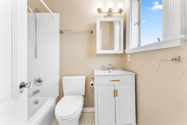 a white toilet sitting next to a bathroom sink