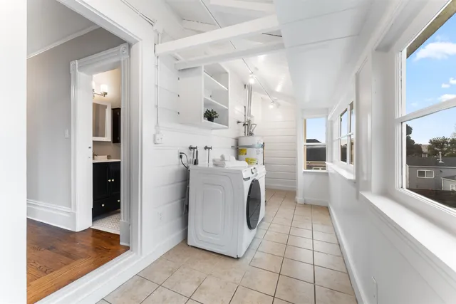 a view of kitchen with refrigerator and cabinets
