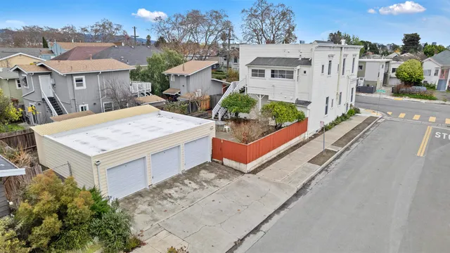 an aerial view of residential houses with an outdoor space