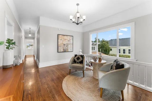 a living room with furniture and a chandelier