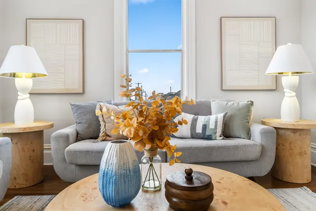 a living room with furniture and a lamp