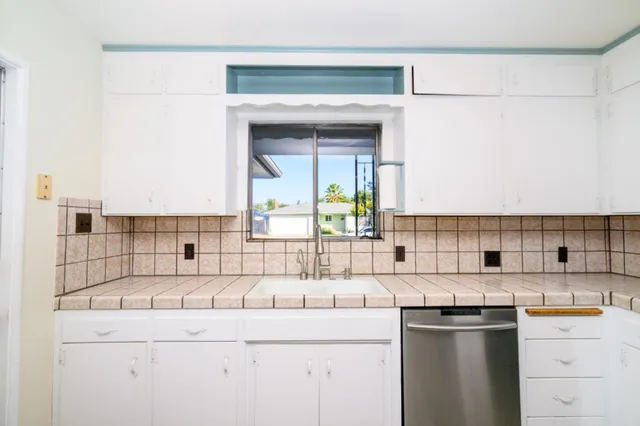 a kitchen with stainless steel appliances granite countertop a sink and a stove