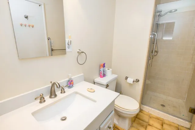 a white toilet sitting next to a bathroom sink