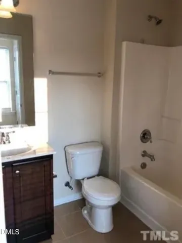 a bathroom with a toilet a sink and bathtub