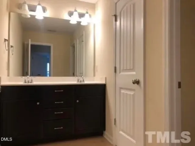 a bathroom with a double vanity sink and a mirror