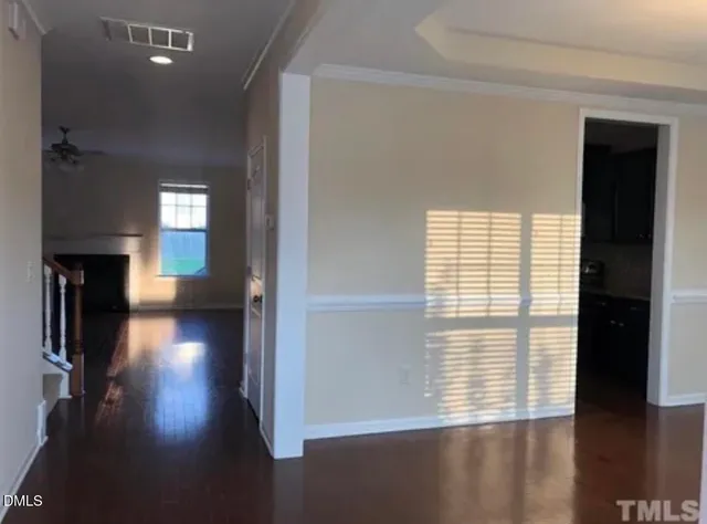 a view of a room with wooden floor and a window
