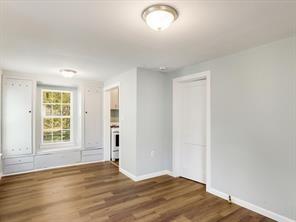 519 Sunnyside Street Cockrell Hill, TX 75211 - Photo 17 of 25 an empty room with wooden floor and windows
