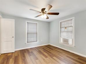 519 Sunnyside Street Cockrell Hill, TX 75211 - Photo 20 of 25 a view of an empty room with wooden floor and a window