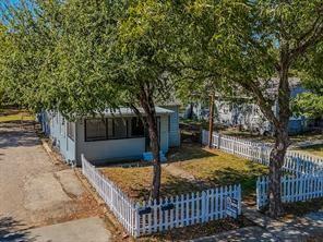 519 Sunnyside Street Cockrell Hill, TX 75211 - Photo 24 of 25 a front view of a house with garden