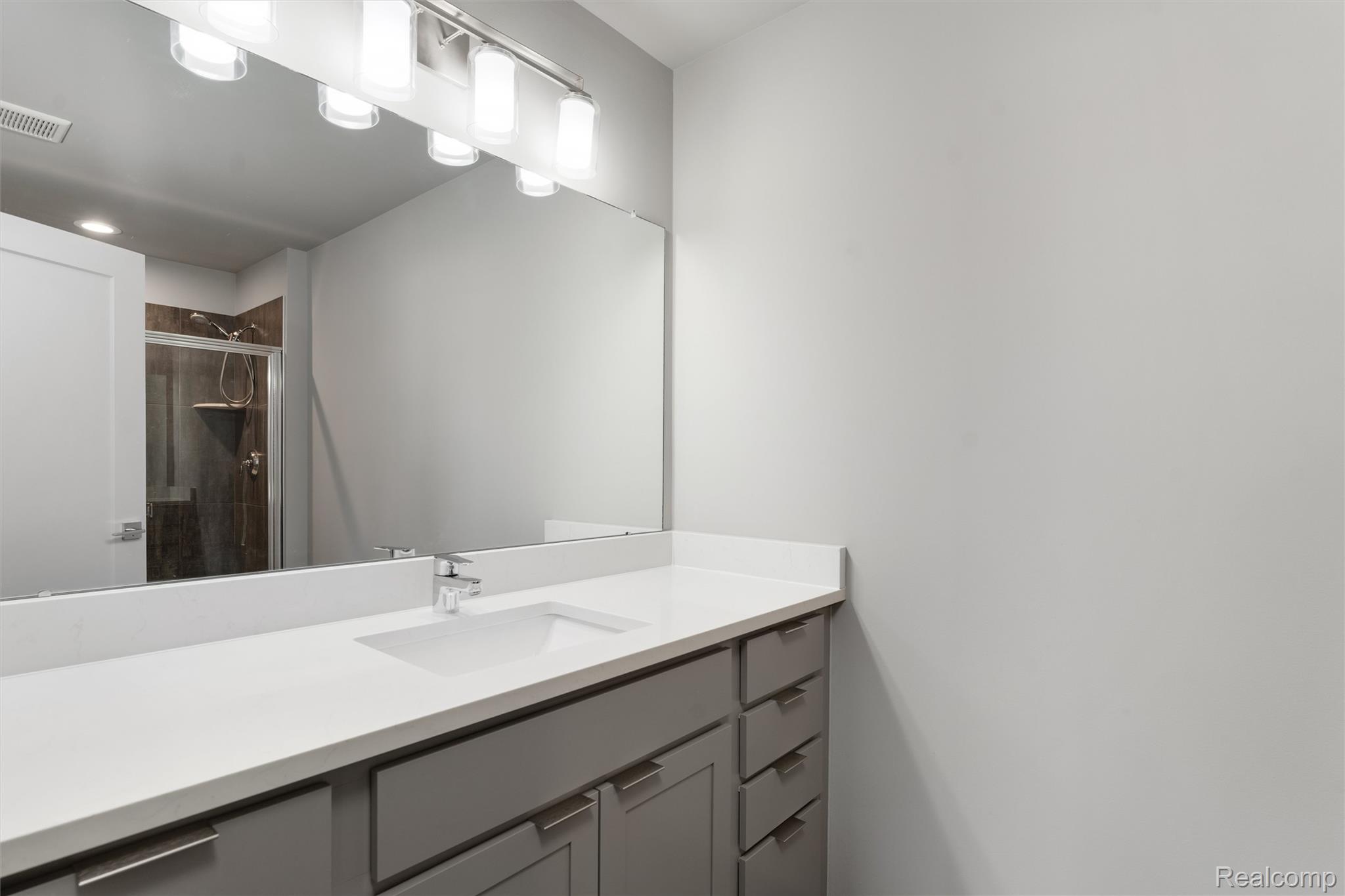 1040 Lamb Road, Unit # 5 Troy, MI 48085 - Photo 16 of 30 Bathroom featuring vanity and a stall shower